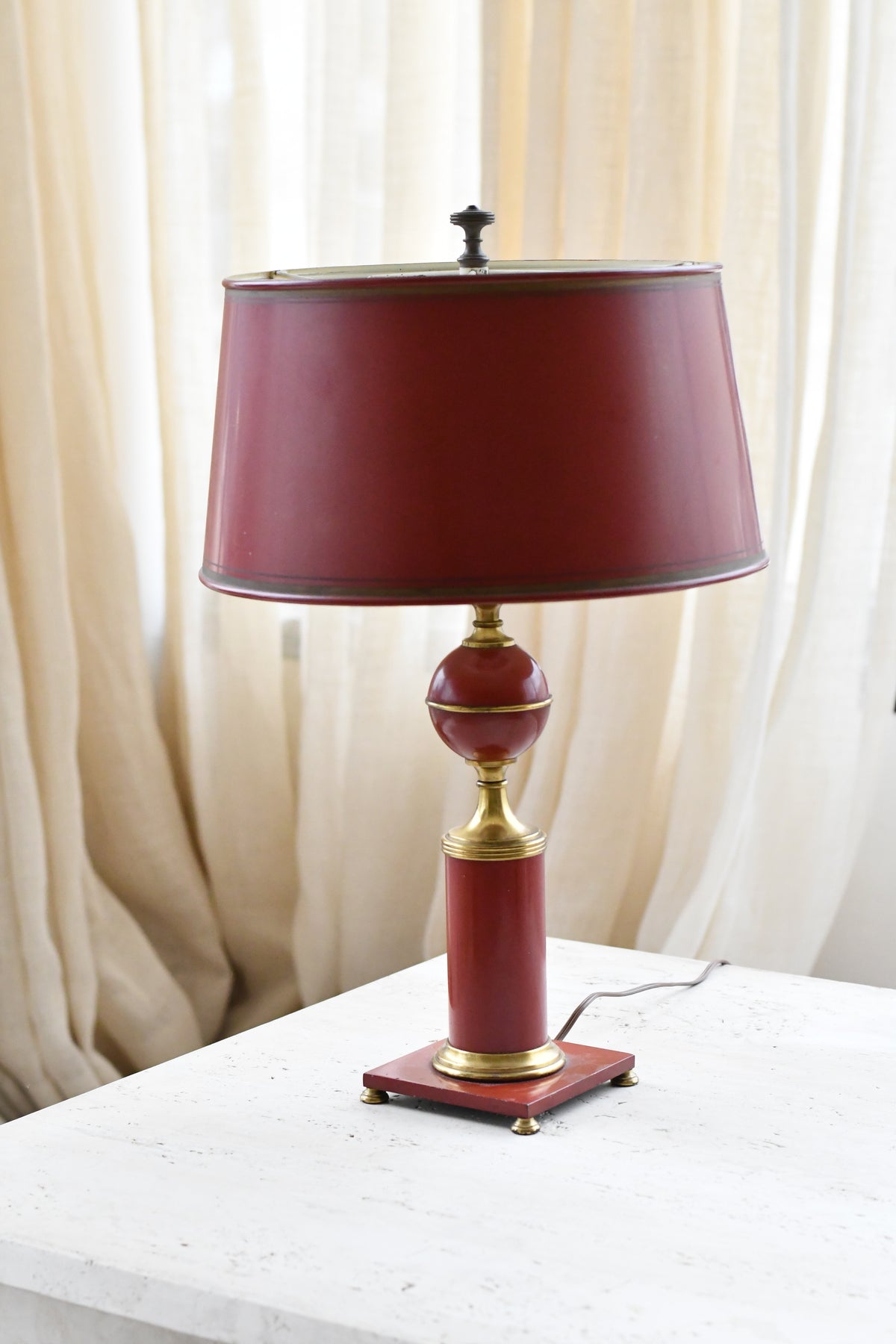 Vintage red tole lamp with brass accents and original shade