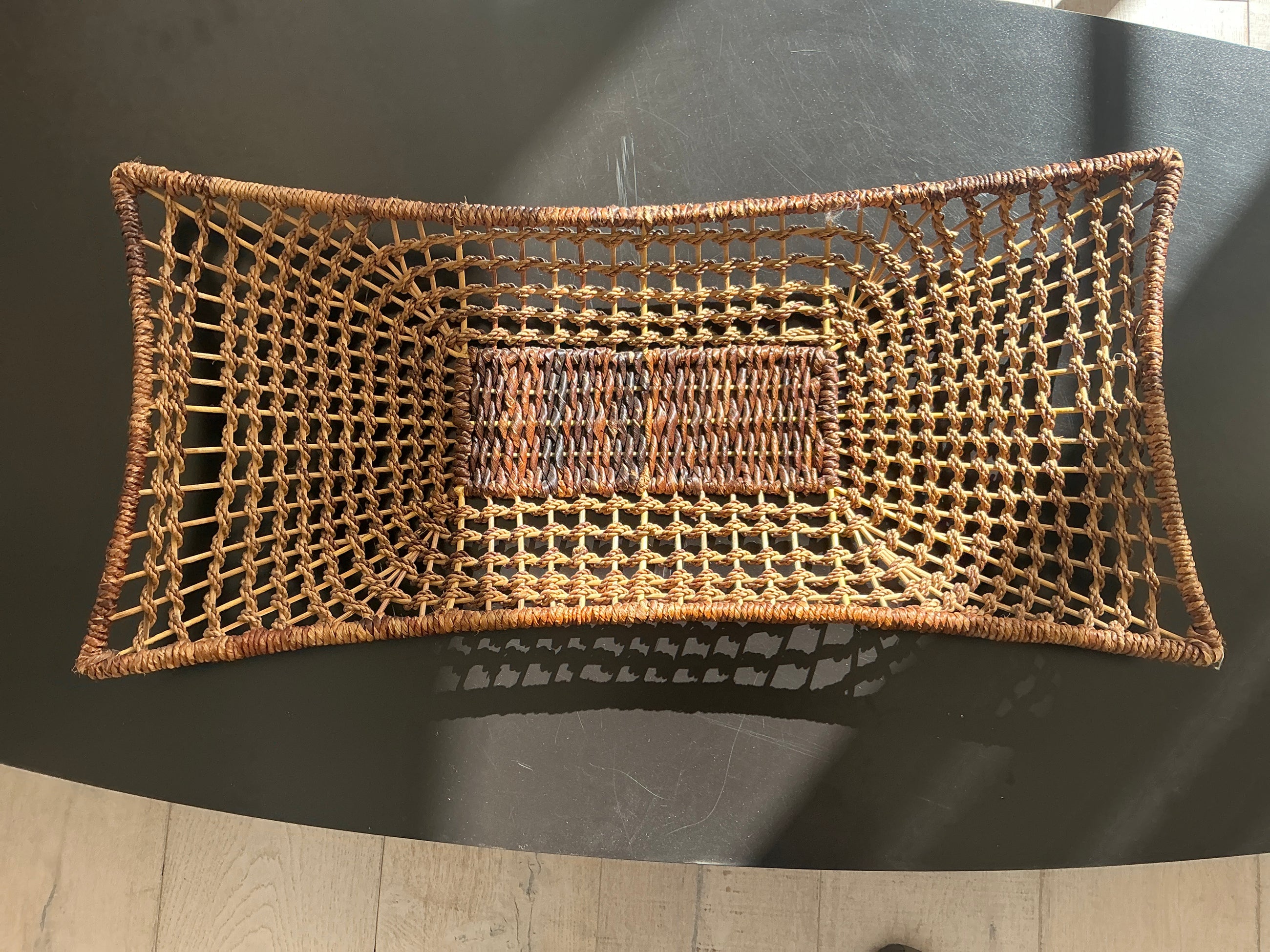 Natural rattan tray with airy woven texture and artisan detail.